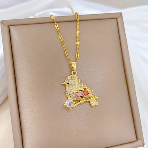 Detailed view of bird pendant with vibrant colorful gems and sparkling zircon pavé