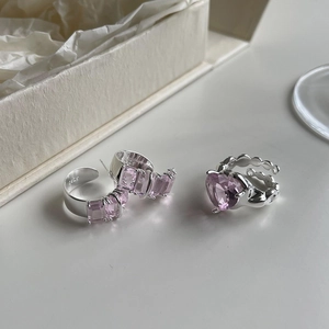 Close-up of S925 sterling silver earrings and ring set with pink zircon crystals