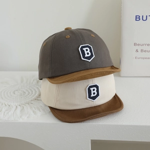 Detail of baby baseball cap featuring letter B embroidery and premium cotton stitching