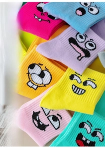 Close-up of colorful funny mid-calf socks with cartoon expressions and ribbed texture