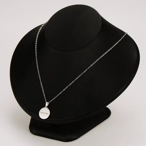 Polished silver Christmas Magic round pendant necklace displayed on a black bust stand