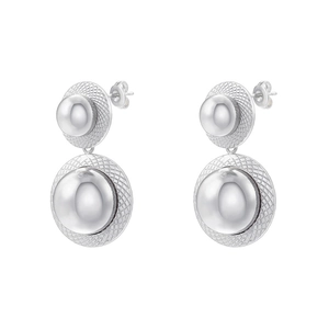 Macro detail of geometric silver ball earrings with textured round stud base