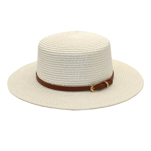 Detailed texture of a white woven boater hat with a brown faux leather buckle strap