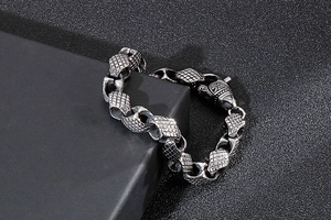 Macro detail of silver geometric link bracelet with punk style textured engraving