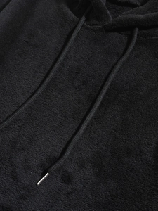 Detail of black coral fleece hoodie showing thick texture and braided drawstrings