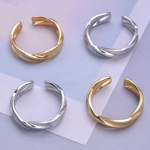 Macro shot of twisted irregular rings in gold and silver finish on gradient background