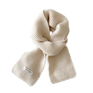 Thick beige knitted winter scarf with a textured weave and brand logo on a white background