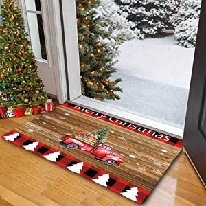 Detail of a Christmas door mat featuring a red truck, wood grain, and Merry Christmas text