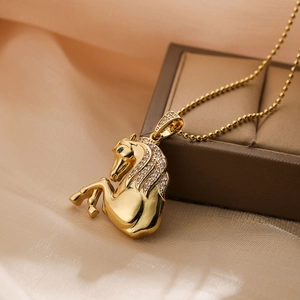 Gold plated horse pendant necklace with sparkling zircons on elegant champagne silk fabric