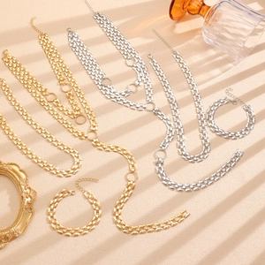 Hip hop punk gold and silver chunky chain necklace and bracelet set in textured lighting