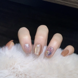 Elegant cat-eye press-on nails with champagne gold glitter and luxury rhinestones decoration