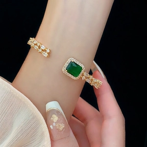 Luxurious open cuff gold bracelet with emerald green gemstone and zircon micro-paving