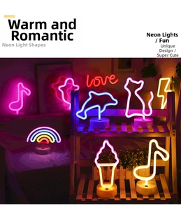 Various LED neon signs on round bases including dolphin cat and love shapes for decor