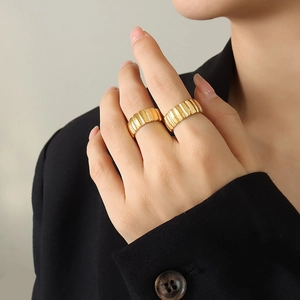 French style 18k gold plated ribbed croissant rings shown layered on a hand