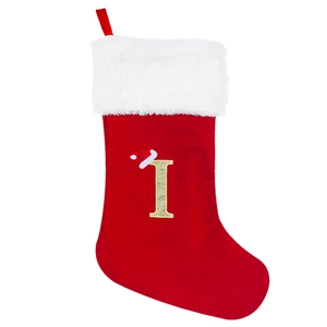 Detail of red velvet Christmas stocking with gold glitter letter I and faux fur cuff