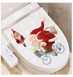Détail de stickers Père Noël sur couvercle de toilette blanc pour décoration de Noël