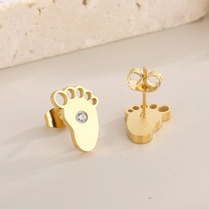 Detailed view of gold stainless steel footprint earrings with tiny zircon stone