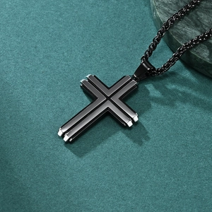 Men's two-tone beveled cross pendant necklace with black rope chain on green stone