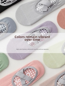 Close-up of cotton yoga socks with cross straps and floral anti-slip silicone dots