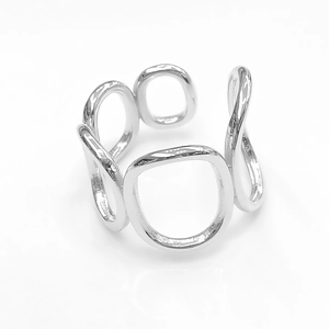 Close-up of hollow silver stainless steel ring with irregular oval link design