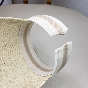 Detail of adjustable elastic striped band on kids straw visor for comfortable fit
