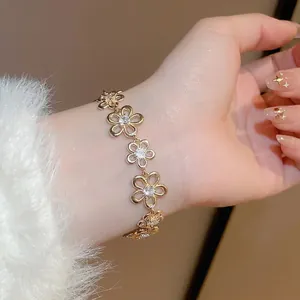 Sparkling zircon hollow flower bracelet in gold plating for women on wrist