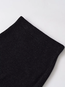 Detailed close-up showing the premium dense knit texture and seam of the black midi skirt