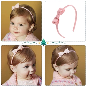 Detailed view of pink bow headband for girls with ribbed fabric texture and soft padding