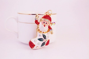 Close-up of Santa boot keychain with red enamel, sparkling rhinestones and gold-tone finish