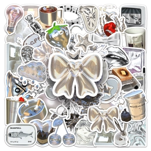 Detail of waterproof Y2K liquid metal stickers with heart and bow motifs for DIY notebooks