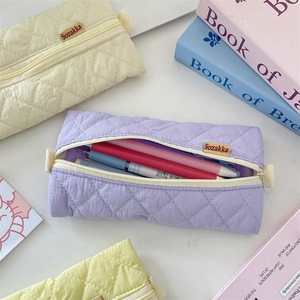 Detail of quilted diamond pattern and zipper on macaron pastel stationery pouches