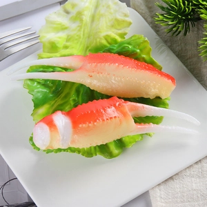 Realistic artificial crab claw food models on a plate for creative display or props