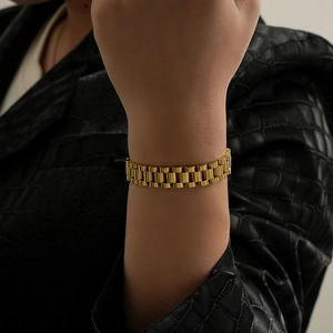 Elegant gold titanium steel watch link bracelet with a polished finish worn on wrist