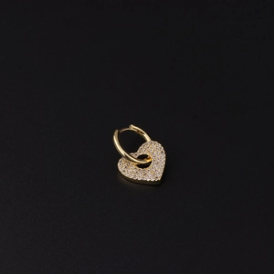 Detailed close-up of a golden heart hoop earring micro-paved with white zircon stones