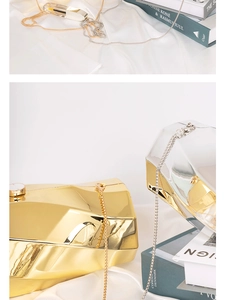 Macro shot of geometric acrylic clutch bags in gold and silver with metal chain