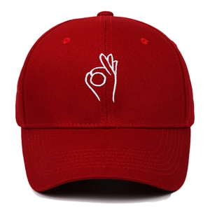 Red cotton baseball cap with white OK hand gesture embroidery in streetwear style