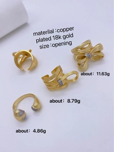 Detail view of 18K gold plated copper rings with weight specs and brushed bow design