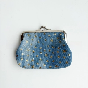 Detail of 4 inch denim coin purse featuring gold star pattern and vintage metal clasp