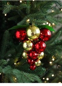 Close-up of red and gold grape cluster Christmas ornaments on a tree branch