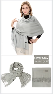 Detail view of silver gray cashmere scarf with soft fringes shown on model and folded