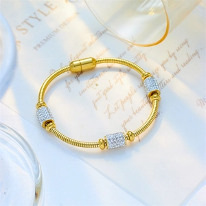 Gold snake chain bracelet with sparkling crystal sliders and secure magnetic closure