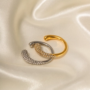 Exquisite gold and silver open rings with white zircon inlay on silk background