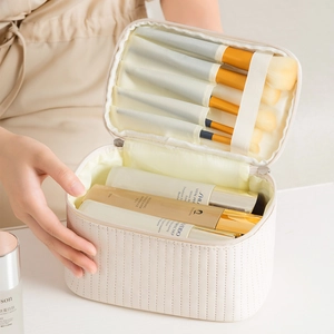 Quilted cream PU leather makeup bag with spacious interior and brush slots