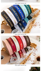 Detail of 2.5cm gold-stamped ribbons with LOVE IS ETERNAL text for floral bouquet packing