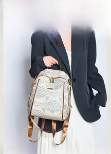 Detail view of retro jacquard backpack with wavy patterns and brown leather straps
