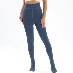 Detail of high-waisted navy thermal leggings featuring tummy control and full footed design