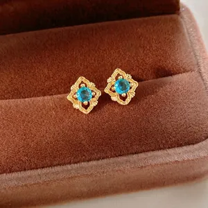 Vintage gold rhombus stud earrings with blue zirconia and intricate hollow patterns