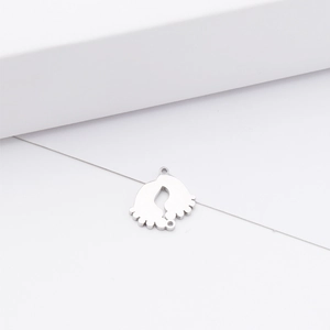 Polished silver stainless steel baby footprints pendant on white geometric display