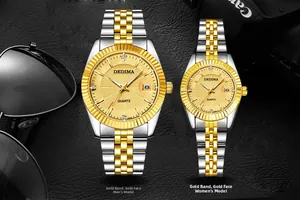 Close-up of stylish couple watches with gold-tone dials and calendars on black leather