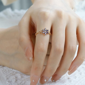 Detail of vintage S925 silver 14K gold ring with tanzanite zircon and opal on finger